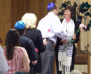 Click for detailed view of image P6045986_-_Congregants_presenting_Susan_with_carnations