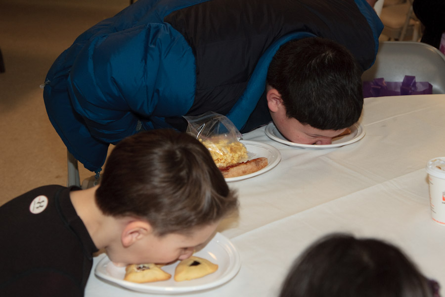 Click to return to grid view of the "Temple Shalom Emeth - 2011-12" gallery "Purim Carnival - Hamantashen Eating Contest (NOT for the squeamish)"