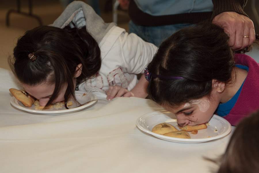 Click to return to grid view of the "Temple Shalom Emeth - 2011-12" gallery "Purim Carnival - Hamantashen Eating Contest (NOT for the squeamish)"